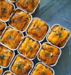 several trays of baked food sitting on top of a table next to each other