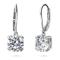 These solitaire dangle earrings offer luxurious sophistication that effortlessly elevates any look. Crafted with sterling silver, rhodium plated, stamped 925, nickel free. Set with premium quality 4 carat total (2 carat per stone, 8mm) round cubic zirconia in 4-prong setting. Earrings measure 0.9" in length, 0.3" in width. Leverbacks. Discount Jewelry, Leverback Earrings, Grade 4, Inspired Jewelry, 925 Sterling Silver Chain, Accessories Jewelry Earrings, 2 Carat, Round Earrings, Sterling Earrings