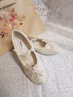 Ivory, or Off-white color lace over satin flat shoes. THESE SHOES DESIGNS ARE HAND DYED AND EMBELISHED TO ORDER THEREFORE, SHOES CAN NOT BE RETURNED OR EXCHANGED; PLEASE MEASURE YIUR FEET LENGHT TO CONFIRM YOUR SIZE FOR THESE PARTICULAR SHOES I'LL MAKE ALL THE EFFORTS TO HELP YOU HAVE A PLEASANT SHOPPING EXPERIENCE. ALTHOUGH THE PICTURES LOOK IVORY, IT IS ACTUALLY OFF-WHITE. HERE'S THE LINK FOR IVORY COLOR: YOU CAN CONTACT ME IF, YOU NEED TO PREVIEW COLOR, I CAN SEND A SWATCH SAMPLE https://www. Elegant Closed Toe Shoes For First Communion, Elegant Closed Toe Wedding Shoes For First Communion, Lace Wedding Shoes With Round Toe, Closed Toe Wedding Shoes With Lace Trim, White Low Heel Lace Wedding Shoes, Wedding Shoes With Lace Trim And Closed Toe, Lace Flat Heel Wedding Shoes For Ceremony, Lace Wedding Shoes With Lace Trim And Round Toe, Flat Heel Lace Wedding Shoes