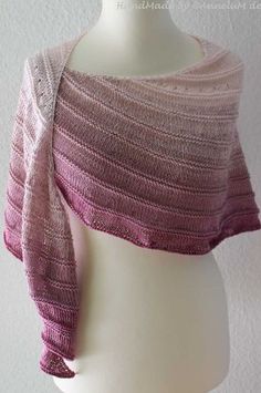 a knitted shawl on a mannequin head