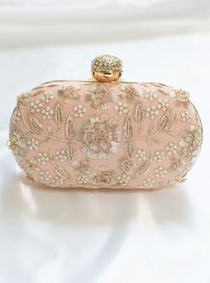 Peach Clutch for Women w/ Zardozi & Pearl embellishment & Gold chain strap Adorned with intricate floral Zardozi embroidery & pearl embellishments. This peach clutch purse with a stone-studded closure at the top is a must-have in your wardrobe - a versatile accessory for any party outfit!  Lining: Fabric Color: Peach Embroidery: Zardozi & Pearl Size & Dimensions:  Height - 5 in Width - 8 in Depth - 1.5 in Fits most of the phones. Strap: Detachable shoulder metal chain strap  Closure: Compartment Feminine Clutch Evening Bag For Party, Feminine Rectangular Clutch For Party, Feminine Clutch For Evening Party, Feminine Rectangular Evening Bag For Party, Elegant Pink Bag For Wedding Guest, Pearl Handle Clutch For Wedding Guests, Pink Embellished Bag For Wedding, Chic Wedding Clutch With Pearl Handle, Chic Rectangular Clutch With Pearl Embroidery