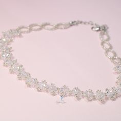 This white crystal bead choker is perfect for cocktail party outfit, wedding party, features shiny white bead with adjustable chain. Add this white rhinestone choker to your everyday fashion jewelry collection or as gift for your love one. Choker length: 13 +2 inches Materials: beads Jewelry Care: See more information about how to care for your jewelry here. Shipping Policy: Orders will be shipped within 1-3 business days. Economy shipping will take 7-14 days to arrive and standard shipping is 1 Adjustable Rhinestone Choker For Formal Occasions, Adjustable White Cubic Zirconia Necklaces, Elegant Adjustable Beaded Choker Necklace, Adjustable White Cubic Zirconia Necklace, Silver Choker With Round Beads For Party, Silver Round Beads Choker For Party, White Cubic Zirconia Crystal Bracelet For Party, Crystal Rhinestone Choker With Adjustable Chain, White Crystal Choker Jewelry