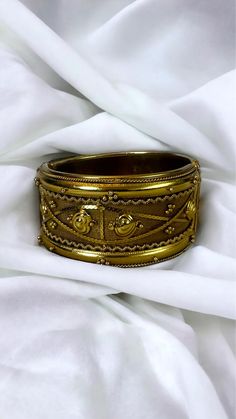 This stunning vintage Extra Wide Mesh Gold-Tone Bangle Bracelet showcases a beautiful Victorian Etruscan Revival style. Featuring a heart-shaped design and an intricate texture, this bold, chunky bracelet is a true statement piece. Measuring approximately 1 1/2 inches (30mm) wide, it's hinged for easy wear and fits most wrist sizes comfortably. Crafted in a bright gold-tone or gilt metal, this unsigned beauty remains in very good vintage condition. While there is light wear on both the outside a Chunky Bracelet, The Bangles, Chunky Bracelets, Hinged Bracelet, Bright Gold, Heart Design, Easy Wear, Bangle Bracelet, Arm Band