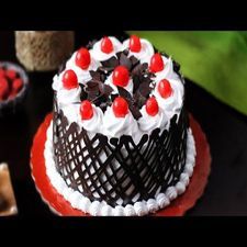 a black forest cake with cherries on top