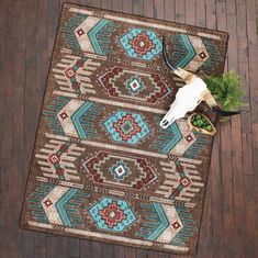 an animal skull is on top of a brown and blue rug with geometric designs in the middle