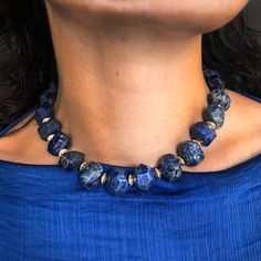 A Chunky Collar of rich Lapis Lazuli with a snake clasp. Lapis lazuli has been associated with royalty, strength and courage, wisdom and intellect, friendship, and truth. In ancient Egypt, it was powdered and worn around the eyes to improve eyesight, and some today consider it an aid to balancing the brow chakra, which influences vision and hearing. Brass beads in between each stone bead are plated in 18K gold. 16" long. All orders over $50 ship for free within the USA. All orders usually ship within 24 hours from NYC. Brow Chakra, To Improve Eyesight, Temple Necklace, Eye Sight Improvement, Lapis Necklace, Lapis Lazuli Necklace, A Snake, Jade Beads, Fine Jewellery Necklace