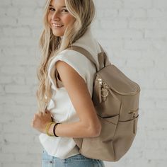 Introducing The Capri, a versatile and chic backpack that is ideal not only for on-the-go moms but also for professionals, travelers, and everyday users. Crafted from resilient microfiber leather, The Capri stands up to daily challenges, resisting cracks, chips, or peels. Its multiple compartments cater to both baby essentials and professional needs, ensuring everything has its place. Effortless to clean, it's the perfect companion for life's little spills, whether from a baby bottle or a coffee cup. With The Capri on your back, step out into the world with style and assurance, no matter your journey. Chic Backpack, Vegan Leather Backpack, Daily Challenges, White Stain, Diaper Bag Backpack, Tablet Sleeve, Baby Bottle, Backpack Travel Bag, Black Friday Shopping