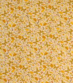 a yellow and brown floral pattern with leaves on it's surface is seen in this image