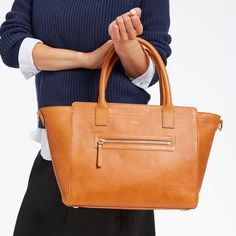 Indulge in the structured beauty of this exquisite bag, designed to elevate your everyday, commute or travel style. The tote is crafted from an exceptional leather produced without the use of any toxic chemicals, resulting in a natural material that is so clean it could be used in organic compost after its useful life has ended. The removable strap lets you wear it on your shoulder or carry in your hand with the robust top handles. Add a monogram for an elegant custom touch.  19"w (top) 12.5"w ( Organic Compost, Toxic Chemicals, Harmful Chemicals, School Days, Natural Material, Zip Top, Leather Working, Corporate Gifts, Travel Style