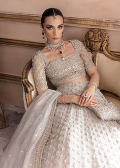 Bridal Grey Lehenga Choli Dupatta Dress for Wedding is a hand-embellished masterpiece that gives the gorgeous bride a head-turning appearance on the big day. Luxury designs and premium details on this stunning Bridal Lehenga Choli make it an epitome of royalty and grace. Choli: Beautiful choli in a classic grey shade is an exquisite choice to pair with Lehenga. The choli comes in organza fabric and is embellished with stones, sequins, and zardosi. Intricate designs, silverwork, and beaming details make this choli a ravishing masterpiece. Lehenga: Bridal Lehenga in the premium quality organza is fully adorned with intricate designs and silverwork. The Lehenga has a huge flare and it comes in an alluring grey shade. Crystals, motifs, sequins, and embellished borders make this Lehenga Dress a Nikkah Brides, Kanwal Malik, Grey Lehenga, Dupatta Dress, Lehenga Dress, Lehenga Bridal, Nikah Dress, Choli Dress, Bride Attire