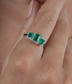 "3 Emerald cut natural Colombian Emeralds paired together in a vintage 18k white gold setting and adorned with 0.19 carats of round cut diamonds.  - Gold Karat: 18K  - 3 Emeralds: 1.03 carat total weight  - Round Diamond: 44 pieces, 1 MM, 0.19 carats  - Emerald origin: Muzo mine, Colombia - Ring Size: 7 1/2 U.S.  SHIPPING TIMES USA: 1-4 business days (USPS) Canada: 5-6 business days Australia: 5-12 business days (Australia Line) New Zealand: 7-20 business days Europe: 5-14 business days Other co Elegant Sterling Silver Emerald Three Stone Ring, Elegant Three Stone Emerald Ring In White Gold, Elegant Three-stone Emerald Diamond Ring, Elegant White Gold Emerald Ring With Three Stones, Elegant Three Stone Emerald Diamond Ring, Elegant White Gold Emerald Three Stone Ring, Elegant White Gold Emerald Three-stone Ring, Luxury Three Stone 14k White Gold Rings, Fine Jewelry Emerald Platinum Ring With Three Stones