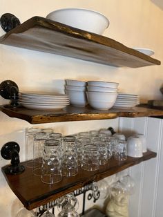 the shelves are filled with glasses and plates