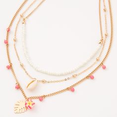 Give yourself a tropical, beachy-vibe with this multi-strand necklace! Three gold-tone chains feature a white seed bead chain, a chain with a seashell. and a chain with pink dangling beads and a monstera leaf and hibiscus flower detail. Finish: Gold-tone Lengths: 12" - 16" + 3" extender Closure: Lobster clasp Material: Metal - Claire's Gold Tropical Floral Seashell Multi Strand Choker Necklace Beach Themed Jewelry, Preppy Necklaces, Tropical Necklace, Barbie Beach, Clay Bead Necklace, Tropical Jewelry, Gold Beach, Rings Ideas, Thick Chain Necklace