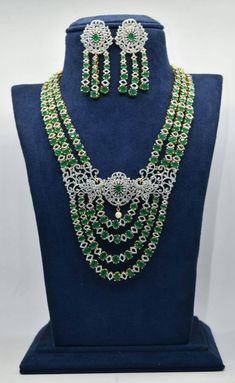 beautiful emeralds & american diamonds necklace with luxurious earrings with back screw.it is plated with 24ct gold. Dazzling Emerald Necklace With Jewels, American Diamond Kundan Necklace For Formal Occasions, Hallmarked Green Diamond Necklace, Exquisite Cubic Zirconia Jewelry For Festive Season, Elegant Kundan Necklace With American Diamond For Formal Occasions, Exquisite Festive Cubic Zirconia Jewelry, Formal American Diamond Kundan Necklace, Dazzling American Diamond Jewelry Set For Celebration, Festive American Diamond Jewelry With Elegant Design