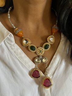 New arrivals for the festival season ♥️ The gorgeous necklace is beautifully handcrafted by our skilled Indian craftsmen in Kundan stones, beads, multi-colored stones, mini pearls, and dual tone plated. The beautiful Statement earrings add to the traditional ethnicity of the piece. Material: Brass with dual-tone plating The drop length of the necklace is 10 inches. It comes with Dori and is adjustable. The length of the earrings is 4.5 cm. The width of the earrings is 3 cm. The weight of the earrings is 24 grams per pair. This is one of a kind designer piece that will make you stand out among the crowd. Luxury Heavy Fusion Necklaces, Silver Kundan Multi-stone Necklace, Festival Pendant Jewelry With Stones, Festive Dangling Beads Dangle Jewelry, Festive Dangle Jewelry With Dangling Beads, Orange Temple Jewelry For Gifts, Orange Temple Jewelry As A Gift, Orange Temple Jewelry Gift, Festive Dangling Bead Jewelry