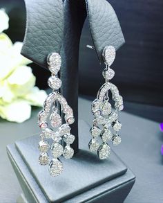 HANDCRAFTED TO PERFECTION! SPECIAL AND LOVELY FLORAL DESIGN, ILLUSION SETTING (APPEARS TO BE LIKE A 0.5-1.0 CARAT BRILLIANT PEAR Diamonds). With over 128 pieces of UNTREATED AND GENUINE F/VS QUALITY SPARKLING DIAMONDS! Perfect for every event! SET IN 18K SOLID WHITE GOLD HANDCRAFTED, CHANDELIER EARRINGS! SUGGESTED RETAIL VALUE: $11,000 DIAMONDS: 254 ROUND BRILLIANT, FULL CUT with excellent firing diamonds, weighting at 3.50 carats. ALL NATURAL, UNTREATED DIAMONDS. ALL DIAMONDS HAVE NO VISIBLE IN Fine Jewelry Diamond White Chandelier Earrings For Party, Diamond White Chandelier Earrings For Party, Dazzling White Gold Chandelier Earrings For Party, Dazzling White Chandelier Earrings With Diamond Accents, Fine Jewelry Chandelier Earrings With Diamond Accents For Party, White Diamond Dangle Earrings, Luxury Diamond Chandelier Earrings As Gift, Formal Sparkling Diamond Chandelier Earrings, Diamond White Chandelier Earrings With Diamond Accents