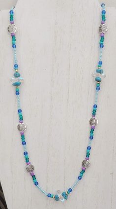 This necklace is made with teal nugget beads, metallic teardrop beads, gold pearls, blue round beads, teal seed beads, silver star beads, and lilac seed beads. Toggle clasp. Measures 24 inches long end to end. Star Beads, Blue Beaded Necklace, Beaded Necklace Diy, Teardrop Beads, Agate Necklace, Blue Agate, Bead Jewellery, Toggle Clasp, Gold Pearl