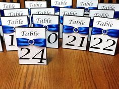 place cards with blue ribbon and name tags