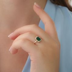 "14k Gold Emerald and Diamond Ring / Solid Gold Diamond Ring / Emerald Engagement Ring / Halo Rectangular Setting / Dainty Emerald Ring ✔ Handmade ✔ Setting Size: 9.5 x 7.5 mm ✔ Diamond Ct Weight: 0.09ctw ✔ Emerald Ct Weight: 1.15 All our emeralds are treated natural emeralds (Emeralds are typically treated with oil or other \"fillers\" to draw the filling substance into any surface-reaching fissures to improve the clarity of the emerald) ✔ Band Thickness: 1.2mm ✔ Solid Gold ✔ Natural Diamonds a Ring Designs With Green Stone, Emareld Ring Design, Emerald Rings Design, Green Emerald Ring Gold, Gold Rings With Green Stone, Gold Ring Emerald Stone, Emerald Gold Rings, Fine Jewelry Green Radiant Cut Diamond Ring, Green Radiant Cut Diamond Ring Fine Jewelry