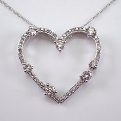 White Gold Diamond Heart Pendant with Chain. This heart is set with fifty-six genuine Round Brilliant Diamonds.  These diamonds are H color, I1 clarity and combine to a total weight of 1/2 carats. This pendant and chain are both 10K White Gold and weigh a total of 2.2 grams. The heart measures 20 X 22 mm. This necklace is accompanied by an appraisal, valued at $1,495.00.  The necklace will be shipped promptly in a gift box. ADDITIONAL REQUESTS If you would like to see more pictures of this item, Wedding Jewelry With Diamond White Heart Pendant, Diamond White Heart Pendant Jewelry For Wedding, Dazzling Heart-shaped Jewelry For Weddings, Diamond White Heart Diamond Necklace For Wedding, Heart Necklace With Diamond Accents For Wedding, Diamond Heart Pendant Wedding Jewelry, Heart-shaped Wedding Jewelry With Diamond Accents, Wedding Heart Necklace With Brilliant Cut, Heart-shaped Diamond Cut Jewelry For Wedding