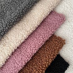 several different colors of towels laid on top of each other