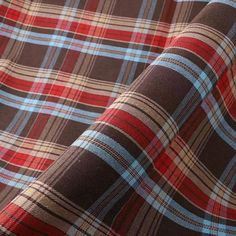 a plaid fabric is shown in red, brown and blue