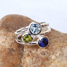 Natural Multi stone Ring 925 Sterling Silver Handmade Ring, Handmade Silver gemstone Ring, Stackable Ring. Metal/Material: 925 Silver Gemstone: Iolite, Peridot, Blue Topaz, Stone size: 6 mm Weight: 4.5 gram approx. Ring Sizes: 5 to 12 US. Please choose on Drop down, Stone Cut: Cut stone Stone Shape: Round Stone Setting: Bezel Band Color: Silver Style: Statement Birthstone: December, August Stone Color: Multi color Finishing: Shiny polished Gemstone Properties: Blue Topaz meaning allows you to ch Luxury Multi-stone Birthstone Ring With Round Cut, Luxury Silver Multi-stone Topaz Ring, Blue Topaz Rings With Natural Stones, Blue Topaz Meaning, August Stone, Topaz Meaning, Bezel Band, Gemstone Properties, Handmade Silver Ring