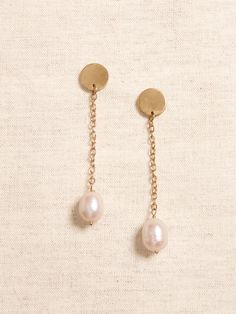 LUSTROUS PEARL COLLECTION: Every pearl is a natural wonder.  With their expansive variety of shapes, colorations, and sizes, our hand-crafted jewelry pairs gorgeous hand-picked pearls with brass or gold-plated brass chains and fittings for a collection of pieces that are perfect for any occasion.  Pretty white drop pearls dangle from delicate brass chains and small circular brass post earrings.  Sterling silver post backs.  Length: 2. 25" (5. 7cm) Everyday Pearl Drop Jewelry, Yellow Gold Jewelry With Pearl Charm, Everyday Drop Pearl Jewelry, Brass Jewelry With Pearl Charm For Weddings, Everyday Gold Pearl Jewelry, Brass Dangle Jewelry With Pearl Charm, Classic Dangle Jewelry With Pearl Chain, Gold-tone Pearl Jewelry With Pearl Drop, Gold-tone Pearl Drop Jewelry