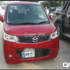 a red van parked next to other cars