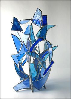 a blue glass sculpture sitting on top of a table