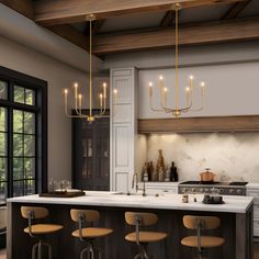 a large kitchen with an island and bar stools next to the counter top that is surrounded by chairs