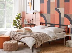 a bedroom with an orange and pink wall