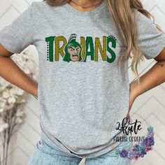 Treat yourself or anyone in your life to this awesome School pride tshirt. It's a Trojans thing.  Great for all occasions.  And great for supporting your trojans team.  Shirt is made of 95% polyester and 5% spandex. It's soft with great stretch.   To get the best wear from your shirt please  1. Wash with mild detergent  2. Do not use fabric softener  3. Do not use bleach 4. Tumble dry low.  Please enjoy your shirt as I know we have enjoyed all the ones we have made for ourselves!! Please note that every shirt is made to order and normal processing time takes us 5-7 business days to create a shirt and ship out an order; however we strive our very best to get it out sooner!  *some shirts are made by a process called sublimation printing. It is normal if you see some minor fading after your f School Spirit T-shirt For Game Day, Varsity T-shirt For College Football Season, Fan Apparel T-shirt With Mascot, Pre-shrunk T-shirt For Football Season With School Spirit, College Football Season Screen Print T-shirt, College Football Season T-shirt With Screen Print, Sports Fan T-shirt With Mascot For Fan Merchandise, Sports Season Mascot T-shirt For Fans, Game Day Fan Apparel T-shirt With Mascot