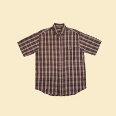 Vintage short sleeve plaid burgundy, brown, and white shirt with a front pocket and a collar, manufactured ca. 1980s by St. Johns Bay. Size M.   - Time Period: c. 1980s  - Brand: St. Johns Bay  - Size: M  - Colors: Burgundy red, brown, white  - Materials: 100% cotton  - Made in: India  - Condition: In good, vintage condition w/ some minor pulled threads/pilling.  Measurements:   - Armpit to armpit: 22.75"  - Shoulder: 18"  - Length: 29.75"  - Sleeve: 10.25" Note: our measurements are taken with Classic Plaid Shirt For Summer, Classic Brown Shirt For Casual Gatherings, Summer Casual Flannel Shirt With Button Closure, Casual Summer Flannel Shirt With Button Closure, Summer Plaid Shirt For Casual Gatherings, Summer Relaxed Fit Flannel Shirt With Button Closure, Classic Plaid Short Sleeve Shirt For Summer, Casual Short Sleeve Flannel Shirt With Button Closure, Brown Relaxed Fit Shirt For Fall