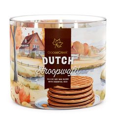 a can of dutch stroopwafel with some leaves on it and a house in the background