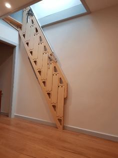 an empty room with a wooden stair case