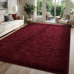 a living room with a red rug on the floor