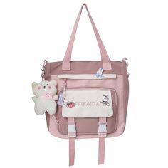 a pink handbag with a stuffed animal and name on the front, attached to it