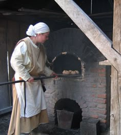 a woman is standing in front of an oven