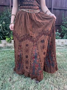 Introducing our Pari Vintage Vibe Brown Embroidery Maxi Skirt, perfect for embracing those boho and hippie vibes! This stunning skirt features pleated borders that add a touch of elegance, while the maxi length offers a chic and comfortable fit.Crafted with fairly-core fashion inspiration, this skirt is ideal for creating enchanting cottage-core looks. Whether you're strolling along sandy shores or exploring hidden getaways, this skirt will ensure you're dressed to impress. Its flowing silhouett Bohemian Full-length Skirt For Festivals, Full Length Bohemian Skirt For Festival, Belly Dance Style Tiered Maxi Skirt For Festival, Spring Hippie Maxi Skirt, Fitted Hippie Maxi Skirt For Festival, Bohemian Lined Skirt, Bohemian Maxi Skirt For Spring, Bohemian Relaxed Skirt, Bohemian Fitted Harem Skirt