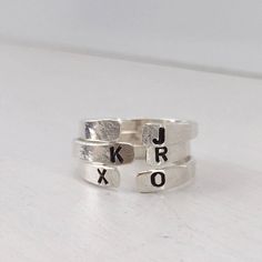 Our Personalized Open Cuff Ring might be small but it makes a mighty statement. This gorgeous minimalist style ring is perfect for stacking two, three, even four or layering with other ring styles. The fact that you can personalize it with initials and other designs just makes it even better, or leave it blank, it's totally up to you. Besides initials this piece can be personalized with numbers, heart, star or flower symbol. This ring is hand made and stamped in our studio at the time of order, Silver Initial Ring, Open Cuff Ring, Rings To Make, Hand Stamped Ring, Stamped Ring, Flower Symbol, Customizable Jewelry, Stamped Rings, Ring Name