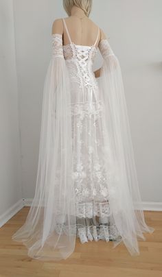 a mannequin wearing a white wedding dress and veil