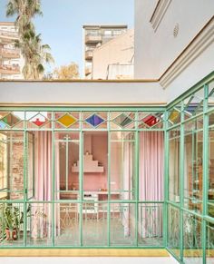 the inside of a house with lots of windows and curtains on the outside side of it