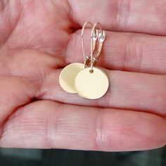 "Cute, Simple, Dainty, says it all. 14k GOLD round circle disc earrings. Choose hammered or smooth. Choose hook ear wires, or lever backs. Details! 1) 14k solid gold 12mm, (a little less than 1/2\") 2) 14k solid gold french hook ear wires or 3) 14k solid gold lever backs Although you can't tell by the photo, they have a shiny finish whether you choose smooth or hammered. You can also choose white gold or yellow gold in the option bar. If you like the earrings with posts, last photo, click here: Clean Sterling Silver, Gold Disc, Disc Earrings, Round Circle, Drop Dangle Earrings, Etsy Earrings Dangle, Ear Wires, My Jewellery, Solid Gold