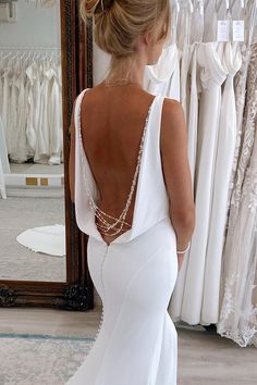 the back of a woman's dress in front of a mirror