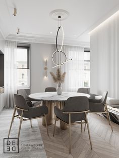 an elegant dining room with white walls and wood flooring, along with gray chairs