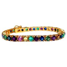 Gem Line. 17.20ct. Natural Blue/Yellow / Pink Sapphires, Green Garnet, Emerald, Ruby & Diamonds bracelet. Full round cuts, great sparkles. Clean Clarity & Transparent. (1) .35ct Natural Round Brilliant Diamond. H-color Vs-2 clarity Secure pressure clasp and safety catch. 18.4 grams. 14kt. yellow gold. Measures 7 inches (wearable length) 5.2mm wide. 37 stones $15,000 Appraisal Certificate to accompany Diamonds Bracelet, Gold Bracelet Set, Bracelet Tennis, Ruby Bracelet, Emerald Bracelet, Green Garnet, Tennis Bracelet Diamond, Ruby Diamond, Natural Sapphire