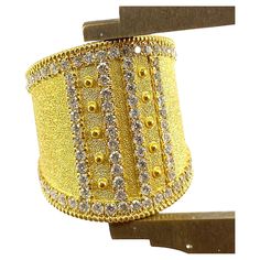 You are admiring S.Georgios designer 18 Karat Solid Yellow Gold Wide Ring all handmade in Byzantine style and a stunning unique velvet background. This gorgeous ring features 1.08 Carats of Brilliant-cut White Diamonds around the edges and in intricate lines. This ring is a beautiful combination of the byzantine technique and a very modern design. This look can be also ordered in all White, or Rose Gold, please contact us. The ring is outstanding in the quality of workmanship and stone collectio Luxury Wide Band Jewelry With Decorative Band, Luxury Gold Jewelry With Decorative Band, Designer Gold Hallmarked Diamond Ring, Luxury Hallmarked Wide Band Jewelry, Luxury Diamond Ring With Decorative Band For Gift, Luxury Yellow Gold Rings With Bling, Yellow Gold Bling Rings For Wedding, Yellow Gold Bling Wedding Rings, Luxury Wide Band Ring With Diamond Accents For Gift