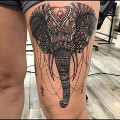 an elephant tattoo on the thigh