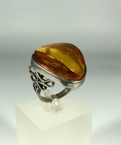 Discover the timeless elegance of our Spectacular Orange-Brown Amber Ring, expertly crafted for ladies in stunning 925 sterling silver. This exquisite piece features natural Baltic Sea amber, renowned for its unique beauty and healing properties. Perfect for any occasion, this amber ring will add a touch of sophistication to your jewelry collection. Product Details: Material: 925 Sterling Silver Stone: Natural Baltic Sea Amber Color: Spectacular Orange-Brown Design: Minimalist Style Ring Size: 8 Amber Open Ring For Anniversary, Silver Cabochon Rings Fine Jewelry, Classic Amber Rings For Formal Occasions, Elegant Amber Oval Rings, Elegant Oval Amber Rings, Luxury Amber Rings For Formal Occasions, Sterling Silver Ring With Shiny Finish, White Gold Rings With Shiny Finish For Gift, Elegant Amber Cabochon Ring